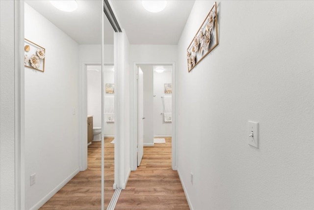 corridor with light wood-type flooring