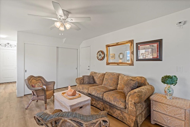 living room with light wood-type flooring and ceiling fan