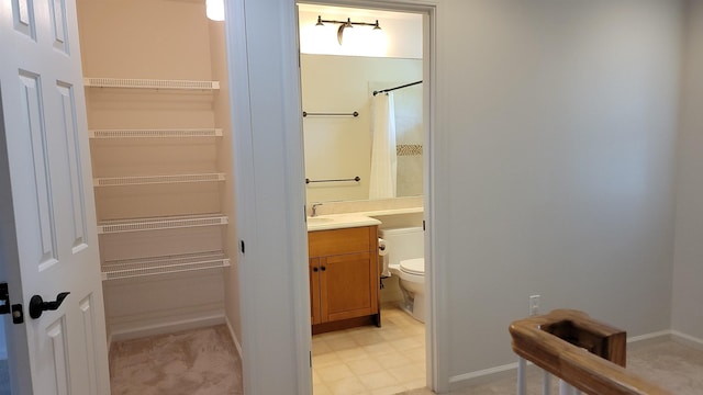 full bathroom with toilet, curtained shower, vanity, baseboards, and tile patterned floors