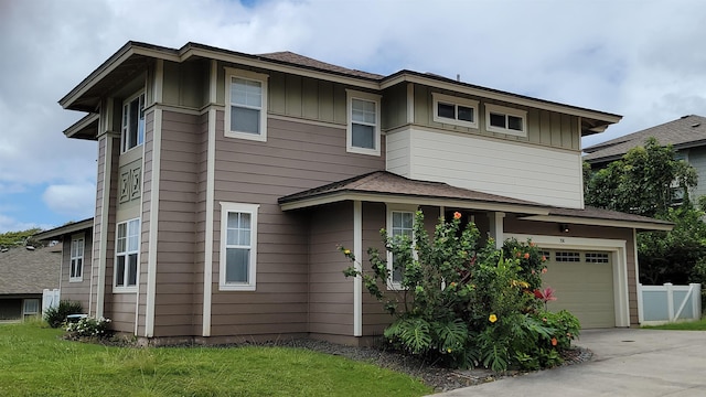 view of front of home with an attached garage, driveway, and board and batten siding