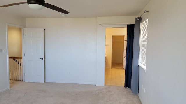 unfurnished bedroom featuring carpet floors, ceiling fan, and a closet