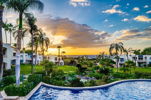 view of pool at dusk