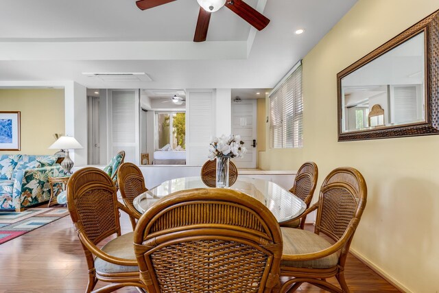 dining space with ceiling fan and hardwood / wood-style flooring