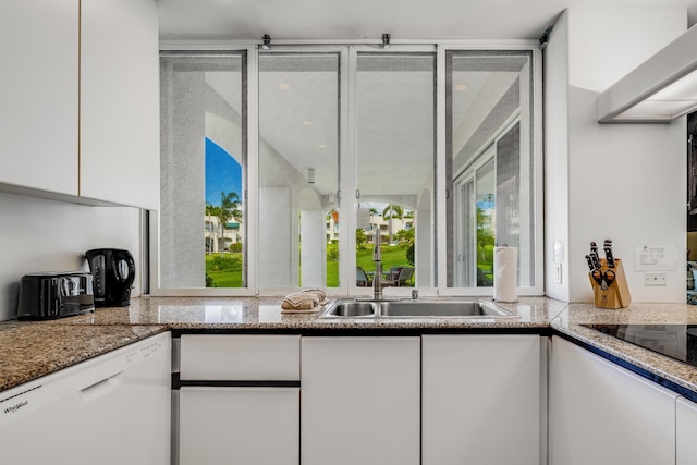 kitchen featuring white cabinets, white dishwasher, a healthy amount of sunlight, and sink