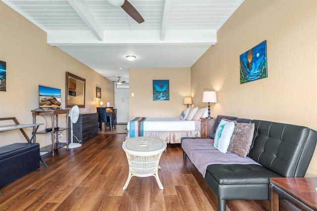 living room featuring ceiling fan, hardwood / wood-style flooring, and beam ceiling