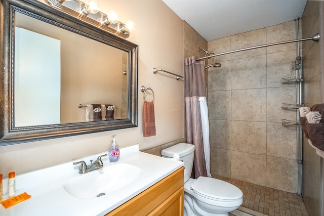 bathroom featuring walk in shower, oversized vanity, and toilet