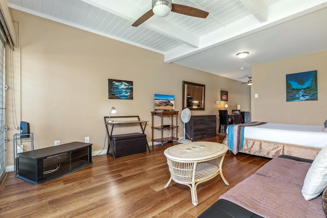 bedroom featuring beamed ceiling, ceiling fan, and hardwood / wood-style flooring