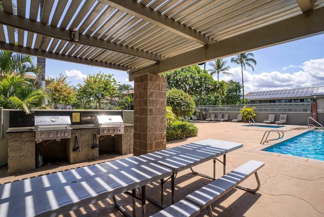 view of patio with a fenced in pool, exterior kitchen, a pergola, and area for grilling