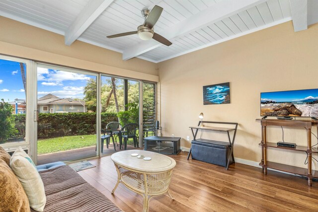 sunroom / solarium featuring ceiling fan and lofted ceiling with beams