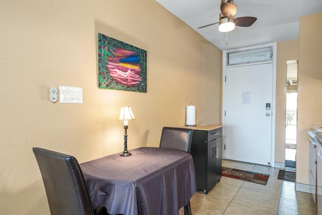 dining space with ceiling fan and light tile floors