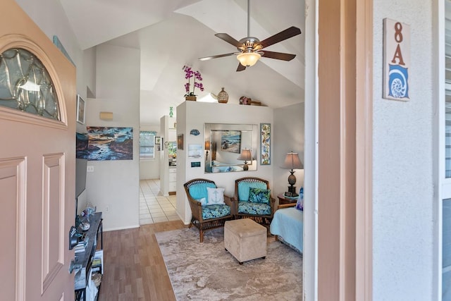 sitting room with vaulted ceiling, ceiling fan, and wood-type flooring