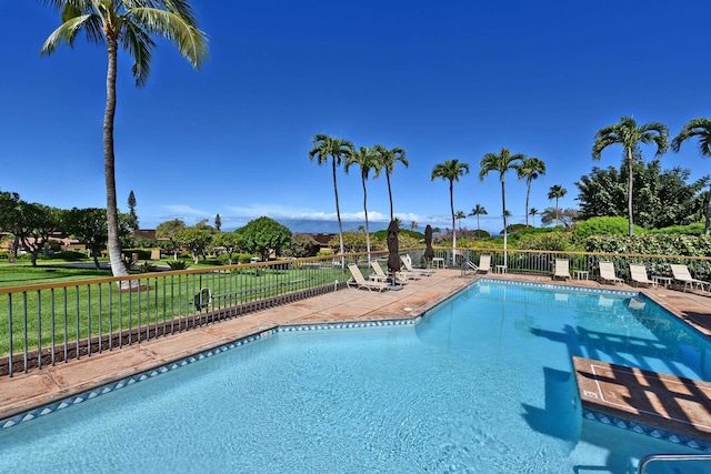 view of swimming pool featuring a lawn and a patio area