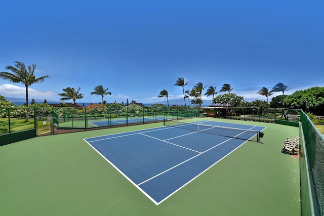 view of tennis court featuring basketball hoop