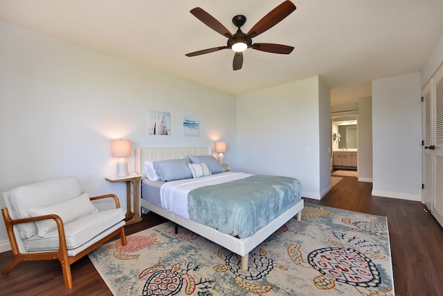 bedroom with connected bathroom, ceiling fan, a closet, and dark wood-type flooring