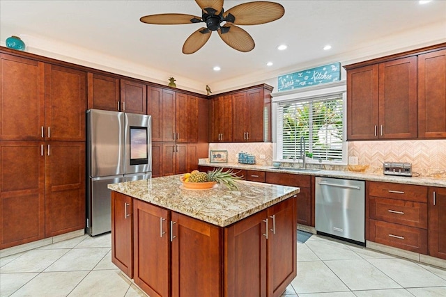 kitchen with tasteful backsplash, stainless steel appliances, sink, and light stone counters