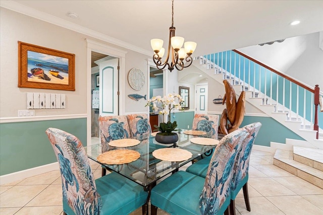 dining room with ornamental molding, light tile patterned flooring, and an inviting chandelier