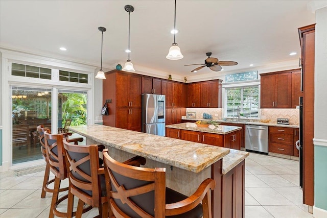 440 Mikioi Pl, Kihei, HI 96753 - kitchen with stainless steel appliances, a kitchen island, light tile patterned floors, ceiling fan, and backsplash