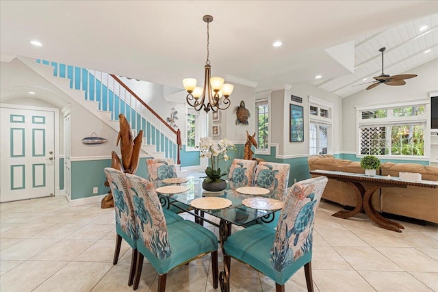 dining room featuring light tile patterned floors, lofted ceiling, and ceiling fan with notable chandelier