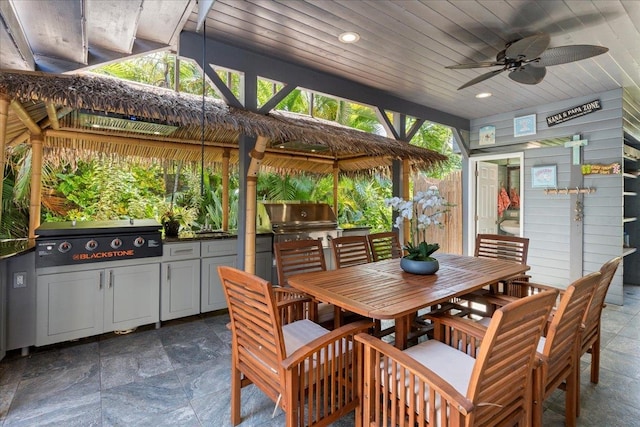 view of patio / terrace featuring a gazebo, ceiling fan, an outdoor kitchen, and a grill