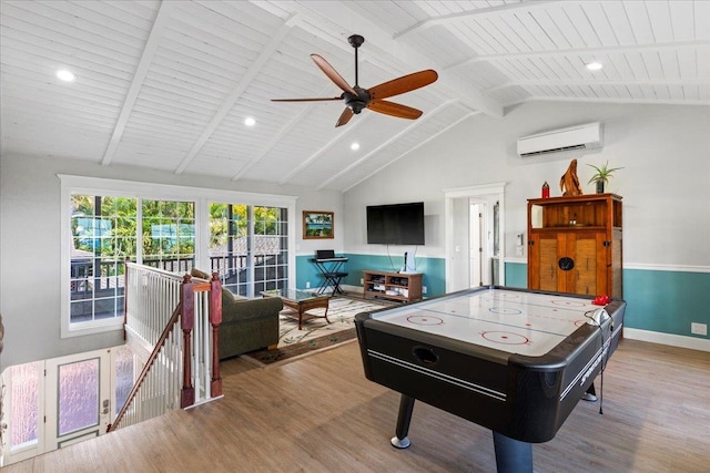 recreation room featuring an AC wall unit, beamed ceiling, light hardwood / wood-style flooring, wooden ceiling, and ceiling fan