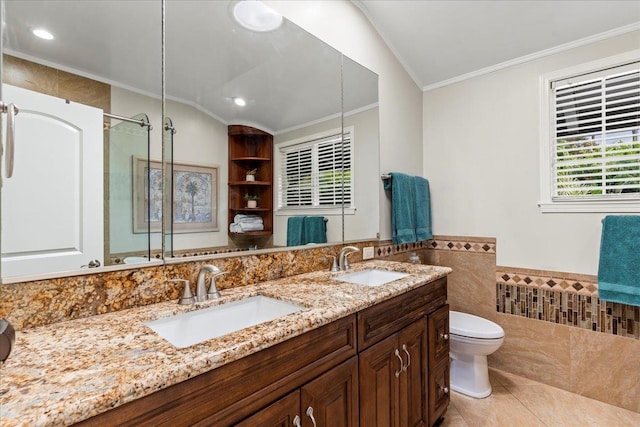 bathroom featuring vanity, lofted ceiling, toilet, and tile walls