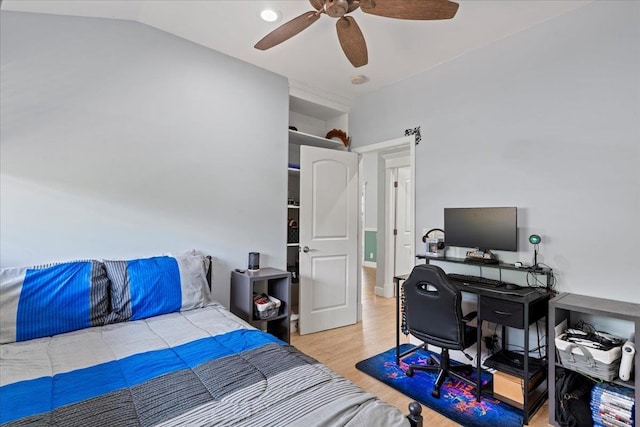 bedroom featuring ceiling fan, vaulted ceiling, and light wood-type flooring