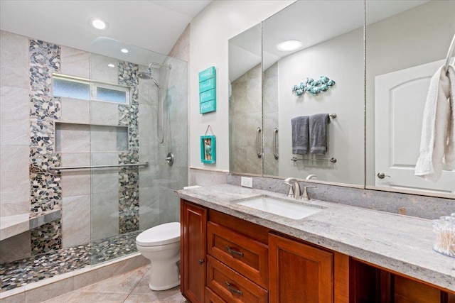 bathroom with toilet, an enclosed shower, vanity, and tile patterned floors