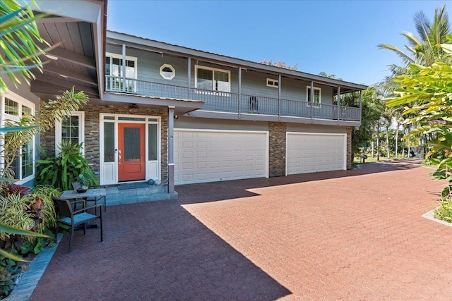 view of front of house with a balcony and a garage