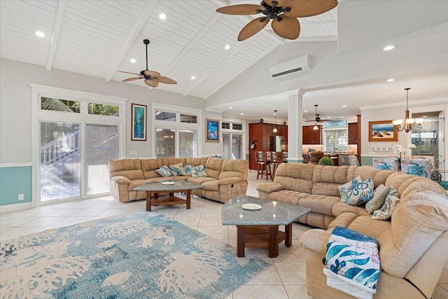 tiled living room with ceiling fan with notable chandelier, ornate columns, a wall mounted air conditioner, and high vaulted ceiling