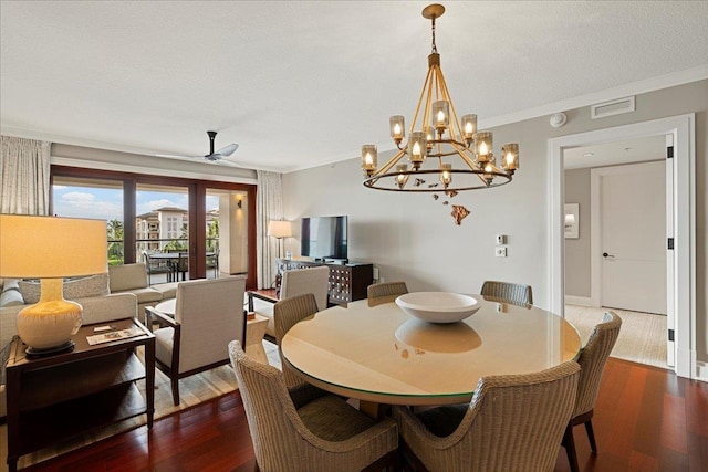 dining area with dark wood-style floors, visible vents, crown molding, and ceiling fan