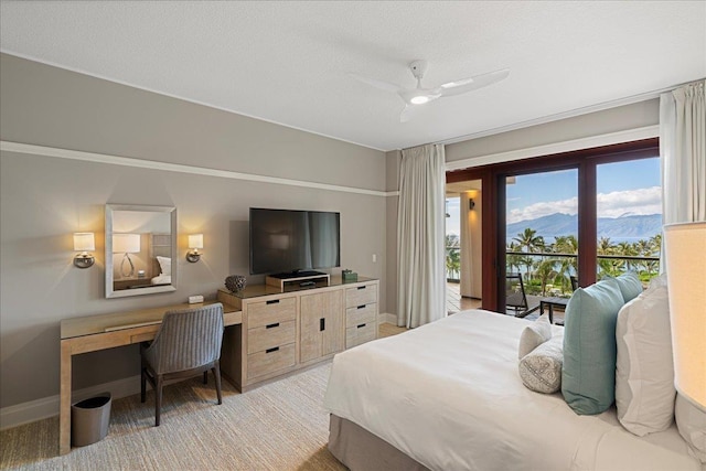 bedroom featuring baseboards, a textured ceiling, a ceiling fan, and access to exterior