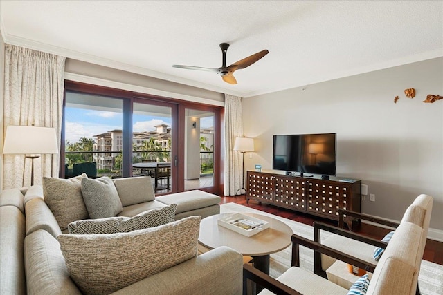 living area featuring ceiling fan, crown molding, wood finished floors, and baseboards