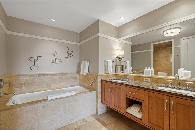 bathroom with a sink, a shower stall, a bath, and double vanity