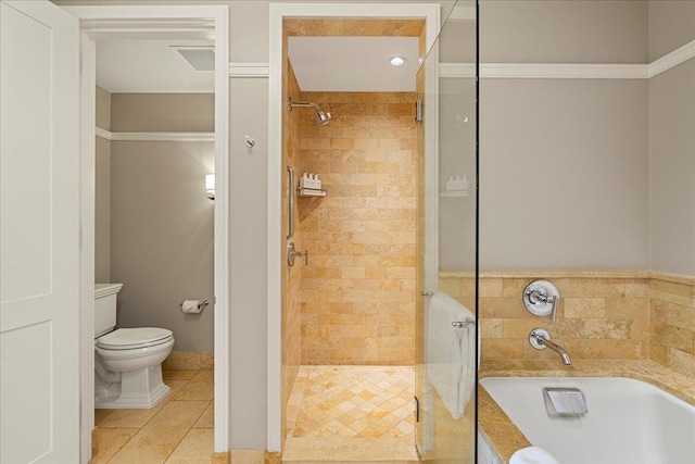 full bathroom with a garden tub, a shower stall, toilet, and tile patterned floors