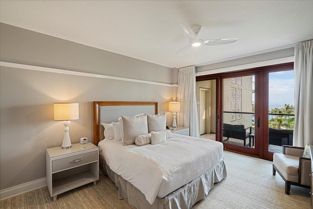 bedroom with access to outside, baseboards, a textured ceiling, and french doors