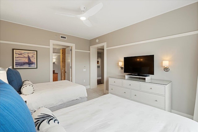 bedroom featuring baseboards, visible vents, a ceiling fan, and light colored carpet