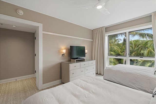 bedroom with ceiling fan and baseboards