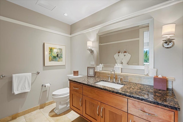 bathroom with toilet, tile patterned floors, and vanity