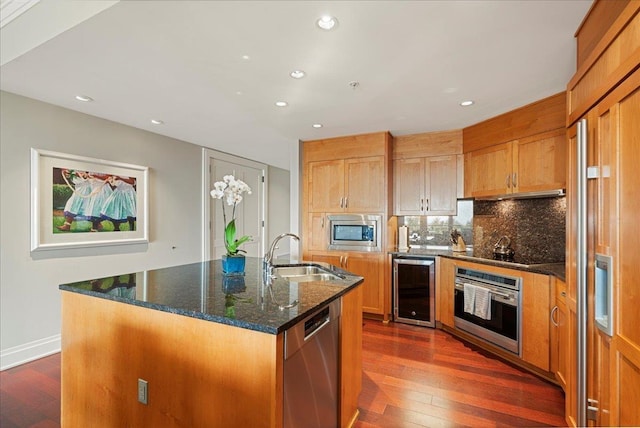 kitchen featuring wine cooler, dark wood-type flooring, a sink, appliances with stainless steel finishes, and backsplash