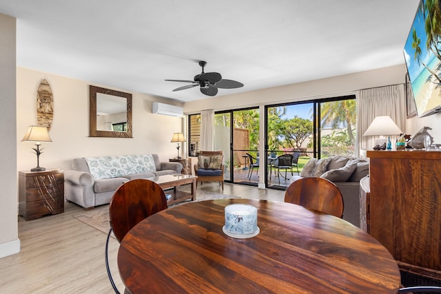 dining room featuring ceiling fan, an AC wall unit, and light hardwood / wood-style flooring