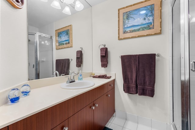 bathroom featuring vanity, tile patterned floors, and a shower with door