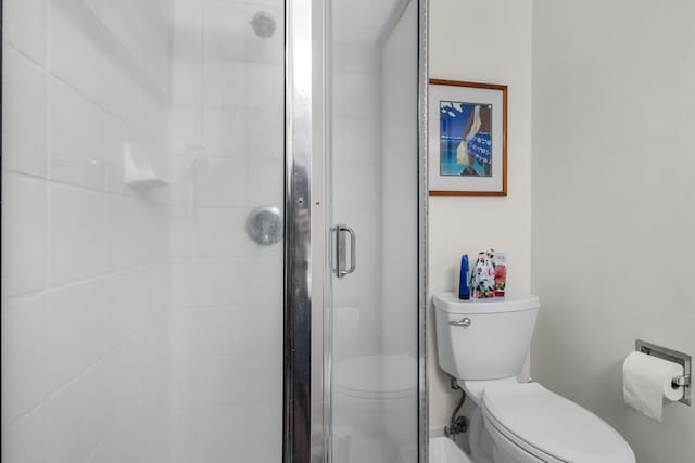 bathroom featuring toilet and walk in shower