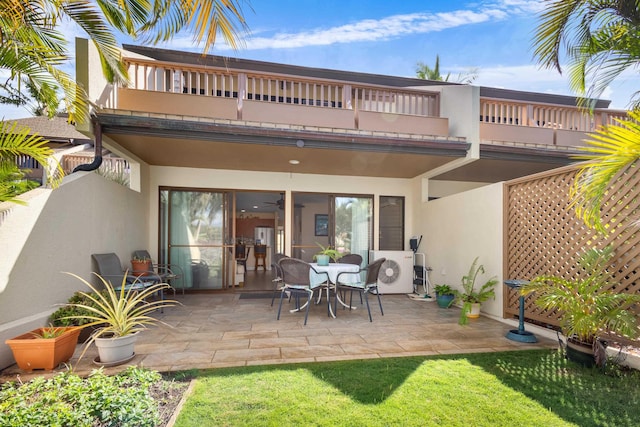 back of house featuring ac unit, a patio area, and a balcony