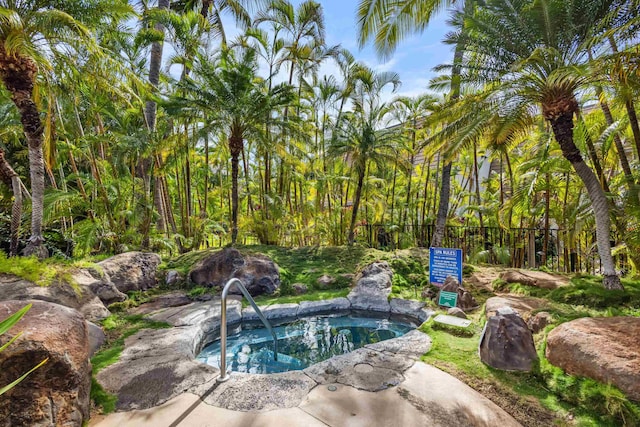 view of pool with a hot tub