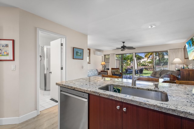 kitchen with light stone countertops, ceiling fan, sink, light hardwood / wood-style flooring, and stainless steel dishwasher