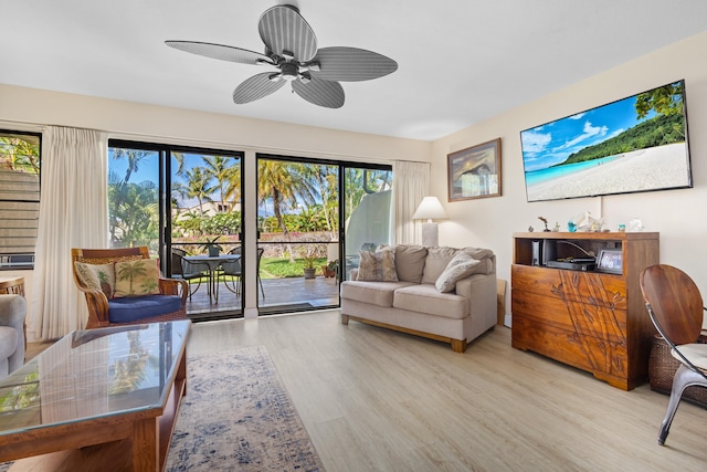 living room with ceiling fan, light wood-type flooring, and a wealth of natural light