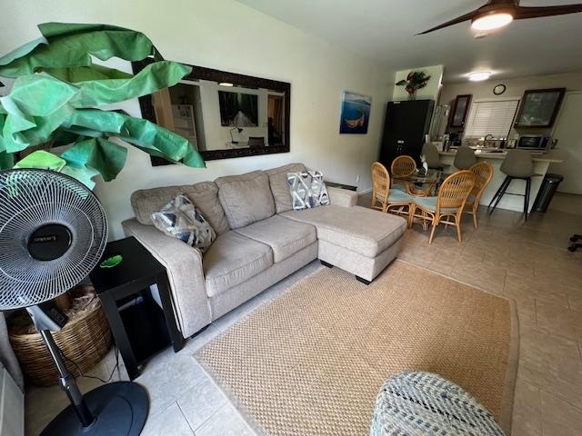 living room featuring light tile patterned floors and ceiling fan