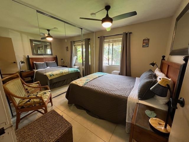 tiled bedroom featuring a closet and ceiling fan