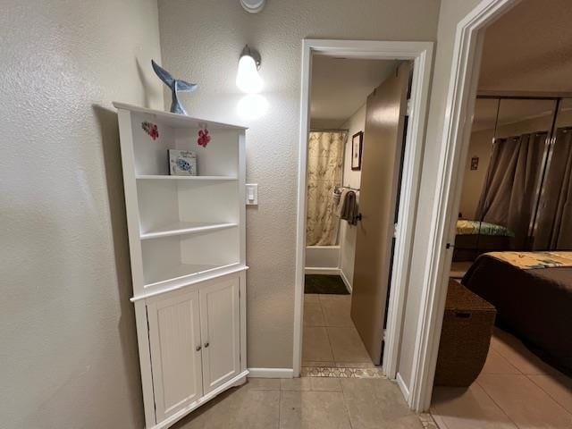 corridor with light tile patterned flooring