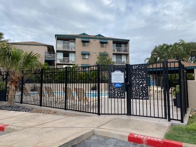 view of gate with a community pool